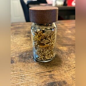 Gold Tone Bracelets in Glass Jar